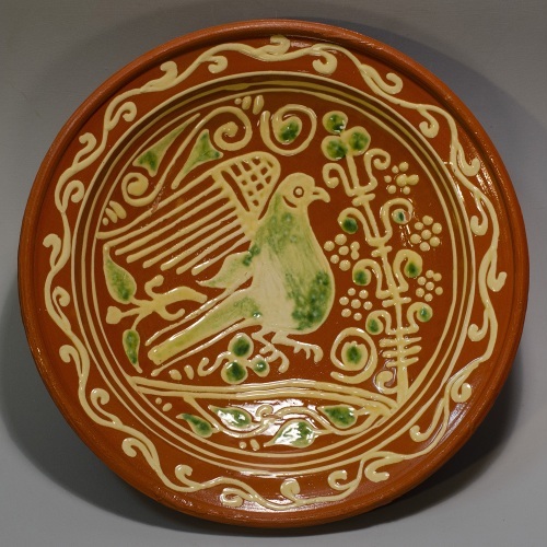 17th century dish with a pigeon and replica to the left