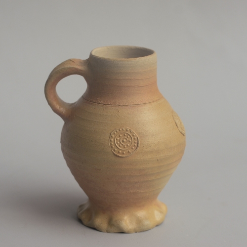replica of a stoneware jug with applied decorations